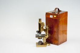 A well preserved brass microscope by Ross in its mahogany case with slide-out lens holder having