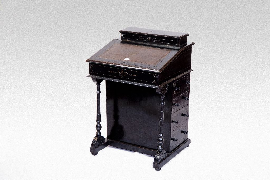 An Edwardian ebonised Davenport desk.