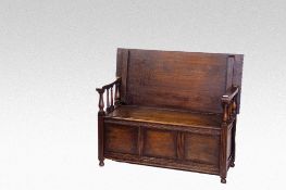 A polished box seat monk`s bench, 40 ins (102 cms) wide.
