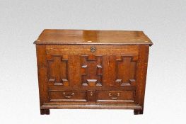 An 18th Century oak dower chest having a triple inset Jacobean style panelled front with one long