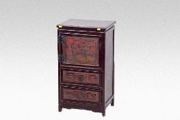 A small Oriental red lacquered cabinet having a top cupboard with figured panel and two small base