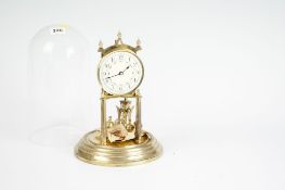 A three hundred and sixty four day brass ball clock with floral decorated dial under a perspex dome.