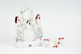 A 19th Century Staffordshire pottery watch-holder group of three female figures; and a pair of