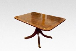 A Georgian mahogany and crossbanded oblong top breakfast table having a turned short centre pedestal