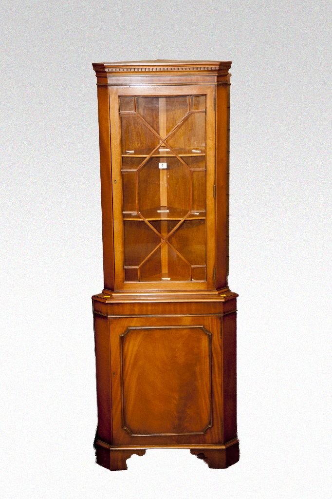 A reproduction lightwood glazed top corner display cabinet.