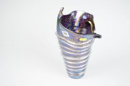 A John Ditchfield Glasform lustrous petrol blue shell shaped tapered vase with lined decoration,