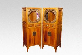 A pair of Oriental hardwood cabinets having open floral fretwork tops with two small centre