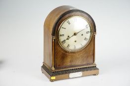 A large mahogany encased dome topped bracket clock with circular silvered dial and Roman numerals