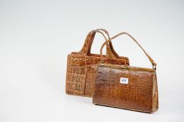 A lady`s crocodile handbag with brass fastener; and a lady`s crocodile handbag with three interior