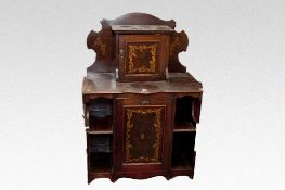 An Edwardian mahogany and inlaid cabinet, the upper section having a shaped back with single