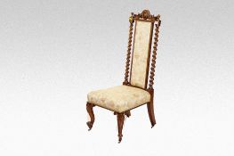 A walnut prie dieu style chair with twist side uprights, narrow floral panelled back with matching