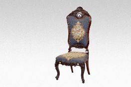 A heavily carved rosewood occasional chair having a floral tapestry back and matching seat on