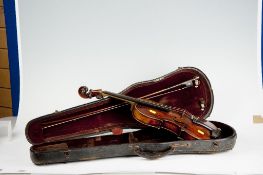 A cased violin and bow, the violin bearing the label of John Carroll, Repairer, Manchester.