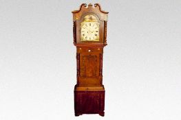A mid to late 19th Century mahogany long case clock, the arched and scrolled hood having candletwist