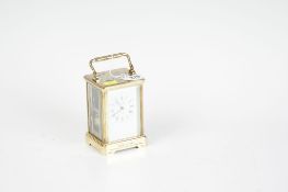 A brass encased non-striking carriage clock with white dial, Roman numerals, French movement and