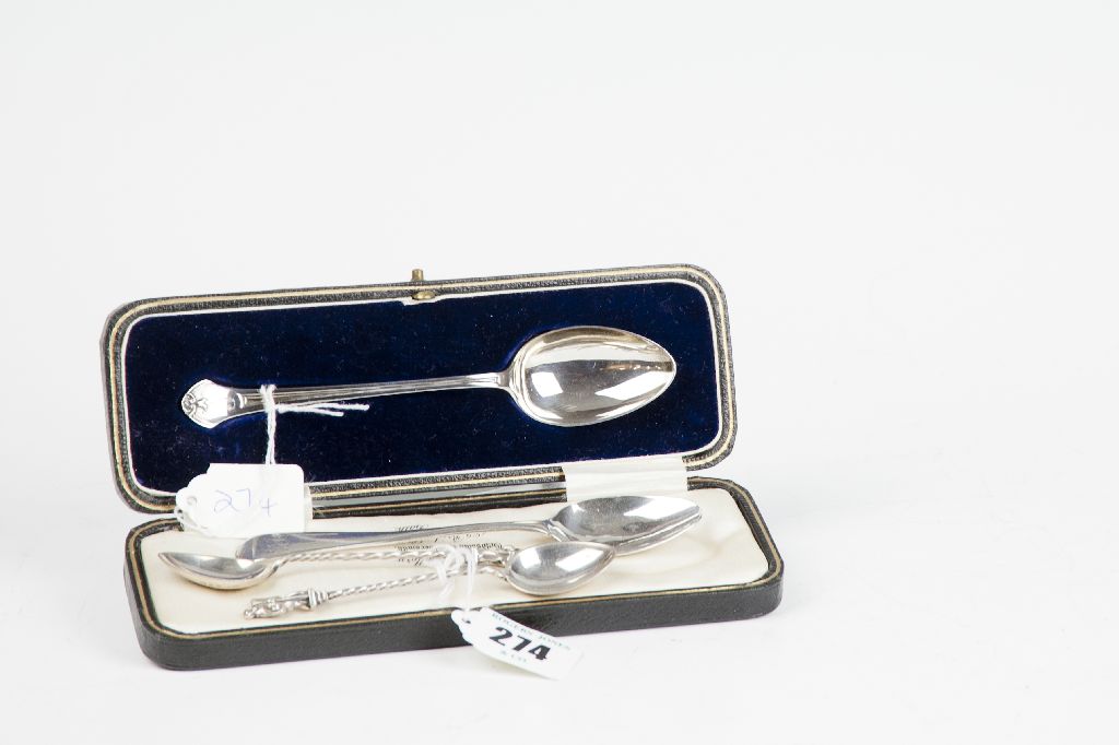 A cased spoon with shaped and reeded handle bearing the initial `J`, 0.8 oz, Sheffield 1928; a