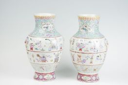 A pair of 18th Century famille rose narrow necked baluster vases, the body having twin wide bands