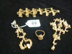 A crusty yellow metal Finish set of bracelet, dress ring and two pendants.