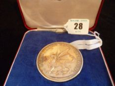 A cased Royal Mint `Prince Charles 1969 Investiture` silver medal, 99 grms (30 ozs).