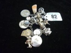 A small sterling and white metal charm bracelet, total 57 grms gross (1.8 ozs).