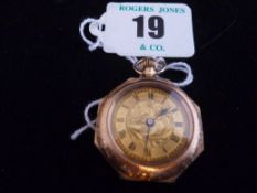 A lady`s nine carat gold encased circular dial octagonal cased fob watch with floral enamel back.