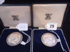 Two cased Royal Mint `Prince Charles 1969 Investiture` silver medals, each 71 grms (2 ozs).