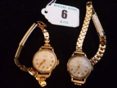 A pair of lady`s circular dial nine carat gold encased Buren `Grand Prix` Swiss wristwatches, each