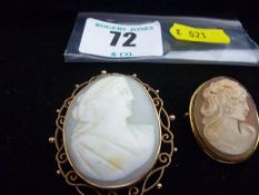 An oval cameo brooch, head and shoulders of a lady in a nine carat gold filigree frame and a smaller