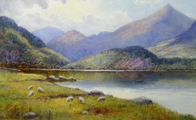 WARREN WILLIAMS ARCA watercolour; Snowdonia lake scene with grazing sheep, signed, 14 x 20.5 ins (33