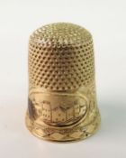 A YELLOW METAL THIMBLE; With town scape engraved oval cartouche within foliate scrolled banded