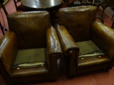 A pair of circa 1930s leather club chairs with stud decoration with geometric styled arm rests on
