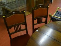 A set of five early 20th Century dining chairs with cushioned seats and backs