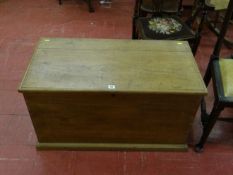 An antique pine linen box with applied handles to sides