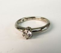 A DIAMOND SINGLE STONE RING; With modern brilliant cut diamond in six claw raised setting on