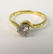 A DIAMOND SINGLE STONE RING; With modern brilliant cut diamond in eight claw setting on crossover