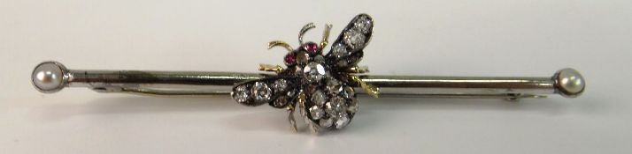 A VICTORIAN DIAMOND AND RUBY BEE BROOCH; With old cut and rose chip diamonds to body and wings
