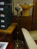 A fine brass floor lamp with reeded column on stepped circular base on three curved feet.