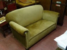 An Edwardian drop end Chesterfield of small proportions in taupe fabric on bun feet