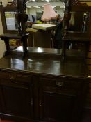 An Edwardian sideboard with mirrored back, two short drawers over two panelled doors
