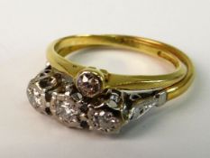 TWO DIAMOND SET DRESS RINGS; The first with three round mixed cut diamonds in platinum illusion