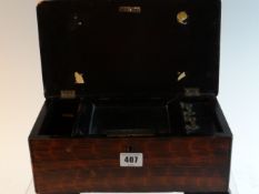 An early 20th Century music box of rectangular form with wood effect painted panels, with hinged lid