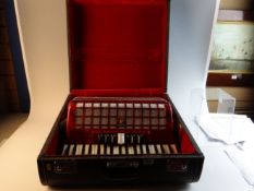 A circa 1960s Chinese cased eighty button accordion by Parrot with red veneered body