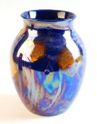 POOLE A blue lustrous baluster vase with stylised floral decoration, 8 ins (20 cms) high
