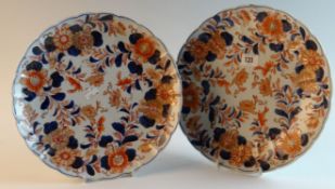 A pair of early 19th Century `Imari` design chargers with floral groups arranged around the rim