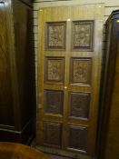 A hardwood domestic door with eight carved floral panels