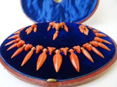 A c.1860-1880 CORAL (CORALLIUM RUBRUM) DEMI PARURE; Comprising necklace, pendant earrings and brooch