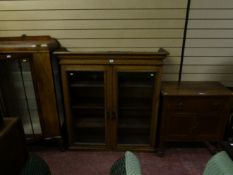 A circa 1930s display cabinet with glass panelled door; a washstand; and a secretaire bookcase top