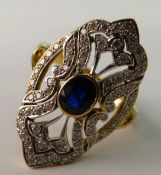 A DIAMOND AND SAPPHIRE COCKTAIL RING; In the Belle Epoque style, the oval mixed cut blue sapphire in