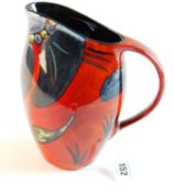 POOLE A red flambé jug with grey stylised floral decoration, 9 ins (23 cms) high