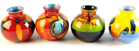 POOLE Four small globular narrow necked vases in flambé style glaze, each 4.5 ins (11 cms) high